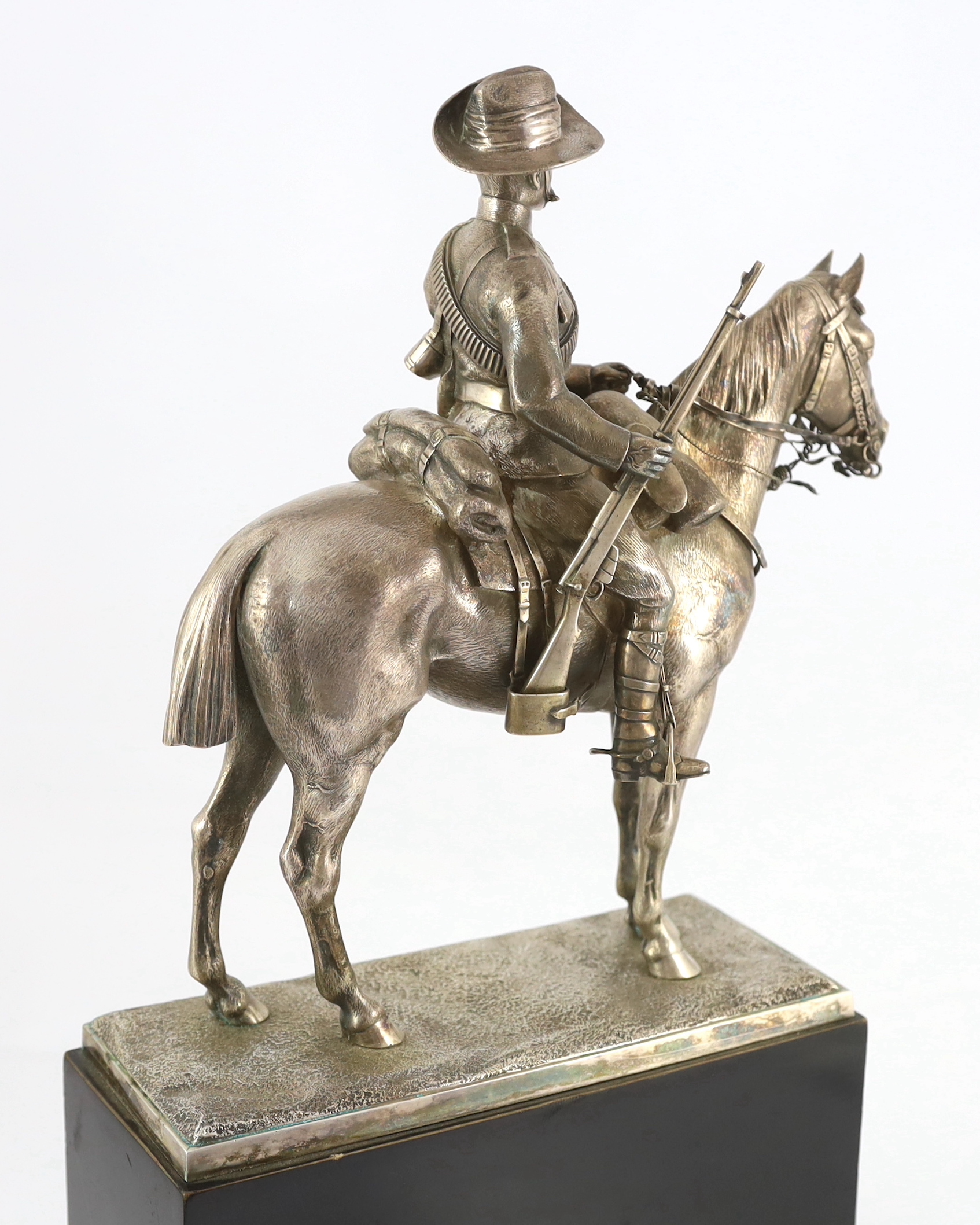 An early 20th century silver model of a City Imperial Volunteer, holding a rifle, on horseback, early 20th century